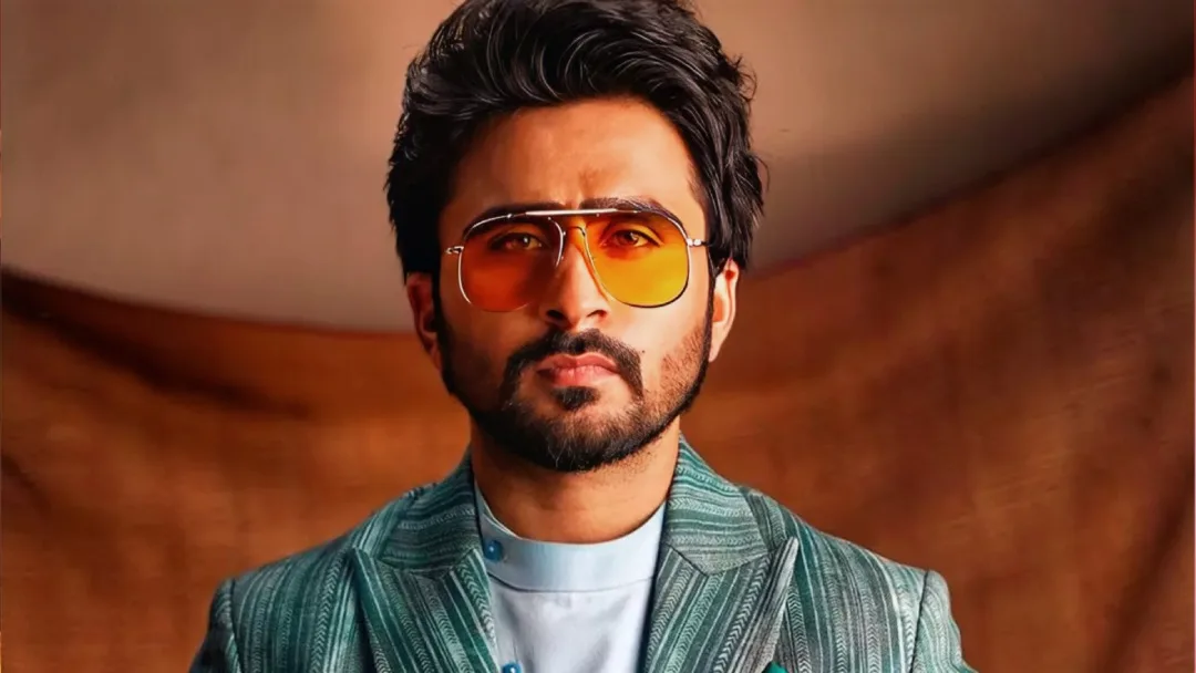 jagjeet sandhu wearing sea green blazer and shades