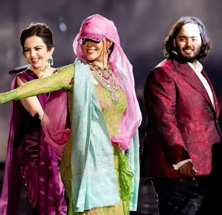 Nita ambani wearing purple saree (on left) riri in middle and anant ambani on right wearing red blazer